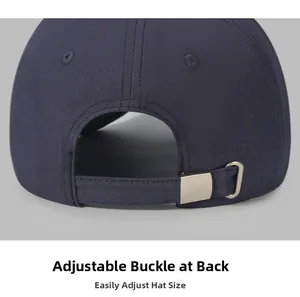Macro detail of the adjustable metal buckle on a navy blue cotton baseball cap strap