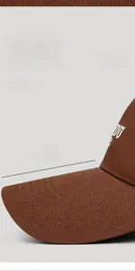 Detail of coffee brown baseball cap featuring a 9cm extended brim and white embroidery