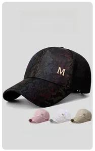 Detail view of breathable mesh baseball cap with sparkling metal M logo and curved brim