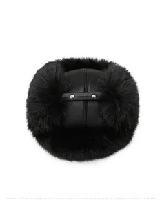 Top view showing matte leather texture and fluffy faux mink fur on black winter trapper hat