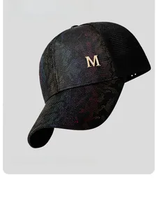Close-up of black breathable mesh baseball cap with metallic M logo and rainbow texture