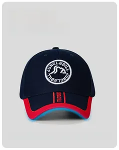 Detail of navy blue baseball cap featuring peak embroidery patch and red brim accents