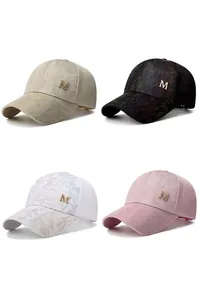 Detail view of four-color mesh baseball caps with camo print and metallic M logo