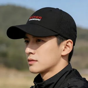Outdoor black baseball cap with side mesh vents and red embroidery in nature