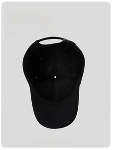 Detail of breathable inner lining and adjustable metal buckle on a black baseball cap