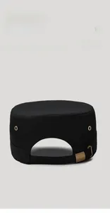 Detail view of cotton flat top cap with adjustable gold buckle and metal eyelets