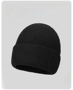 Detail view of black ribbed knit beanie with vertical weave texture and fold-over cuff