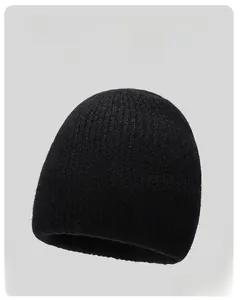 Close-up of black ribbed knit beanie showing soft texture and high-quality warm material