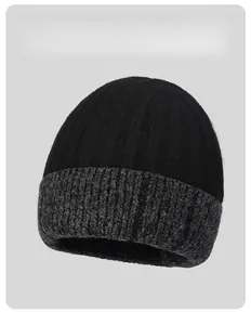 Detail of winter knit beanie showing two-tone black and grey textured wool fabric