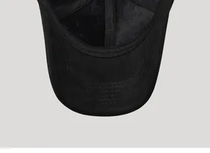 Detailed view of black suede baseball cap showing reinforced stitching and matte fabric texture