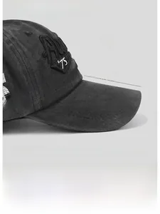 Detail showing the 8cm extended brim of the vintage dark gray embroidered cotton cap