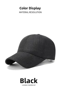 Detail of classic black baseball cap fabric showing fine check texture and curved brim