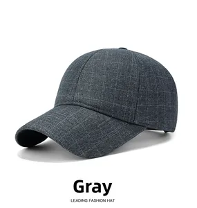 Detailed view of dark grey plaid fabric texture and stitching on a winter baseball cap