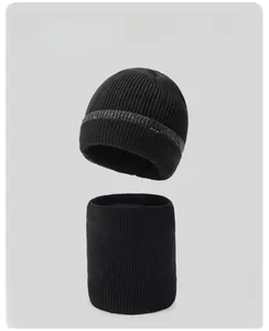 Close-up of black winter knit beanie and neck warmer set with grey stripes and star detail