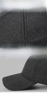 Detailed view of the plaid fabric texture and precise stitching on the winter baseball cap