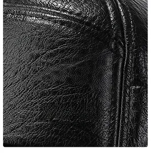 Macro shot of black PU leather baseball cap featuring fine lychee texture and neat stitching