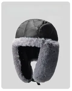Detail of warm winter trapper hat with gray faux fur lining and windproof quilted fabric