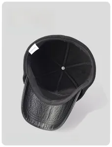 Detailed macro view of the thick black fleece lining and PU leather visor on winter cap
