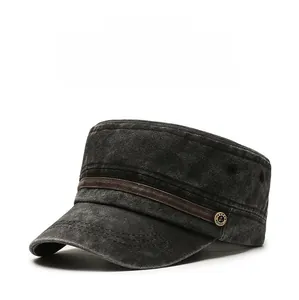 Close-up of washed cotton flat top hat with brown leather strap and metal badge detail
