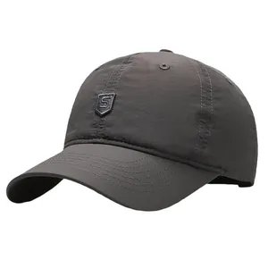 Dark grey quick-dry baseball cap with a small shield logo on a plain white background