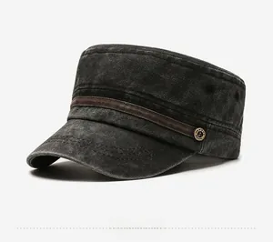 Detail of charcoal washed cotton flat top hat with bronze anchor badge and leather strap