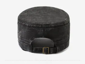 Detail of adjustable metal buckle and washed cotton texture on a black cadet cap