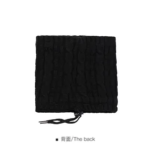 Rear view of black cable knit neck warmer with adjustable drawstring and toggle