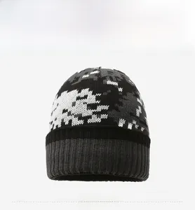 Front view detail of winter knit beanie showing gray black and white camouflage pattern