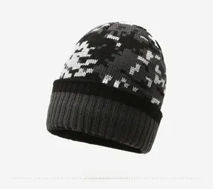 Detail view of winter knit beanie showing gray pixelated camouflage and ribbed cuff