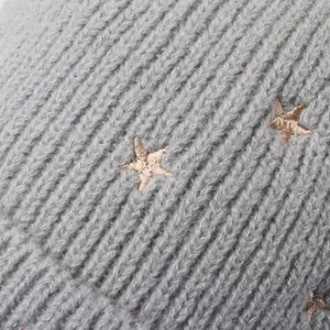 Grey ribbed knit hat featuring detailed gold star embroidery for kids and toddlers