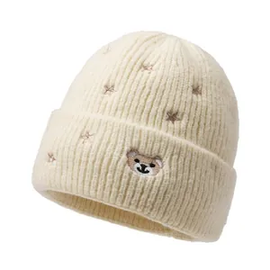 Cream knit beanie for kids with cute bear embroidery and stars, cozy ribbed design