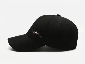Detailed side view of black quick-dry baseball cap with breathable mesh and side lettering