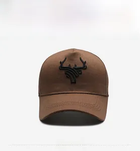 Front view showing detailed black 3D embroidery on a dark brown cotton baseball cap