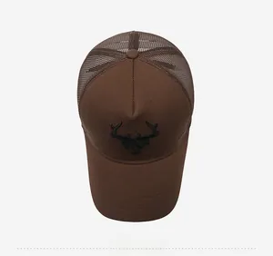 Top down view of dark coffee mesh trucker hat featuring black deer antlers embroidery