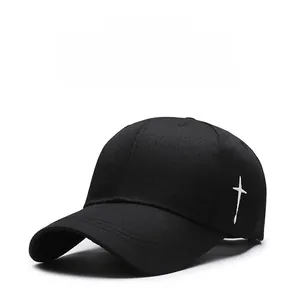 Detail shot of white cross embroidery on black twill cotton baseball cap side