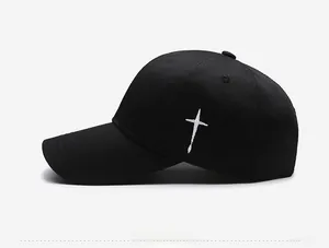 Detailed side view of black cotton baseball cap with white cross embroidery
