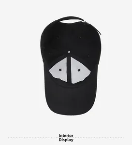 Interior view of black cotton baseball cap showing reinforcement and adjustable metal buckle