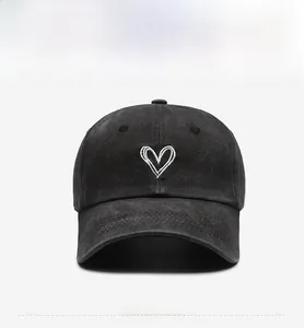 Front view of washed dark grey baseball cap featuring white double heart embroidery