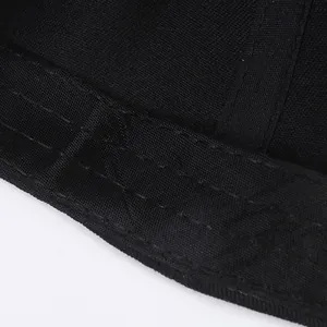 Black baseball cap interior detail with reinforced stitching and breathable mesh texture