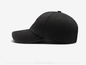 Side view of black washed cotton baseball cap with heart embroidery and curved brim