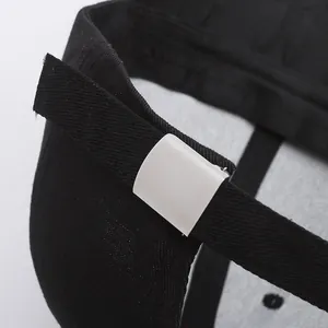 Black cotton baseball cap with adjustable metal buckle and twill fabric texture