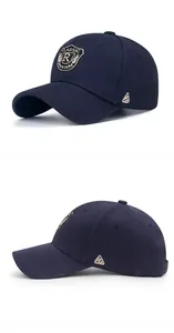 Detail view of navy blue baseball cap with shield embroidery and metallic side logo