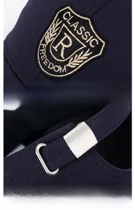 Detailed view of R letter embroidery and adjustable metal buckle on baseball cap