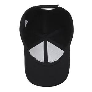 Interior view of black cotton baseball cap showing stitching and adjustable velcro strap