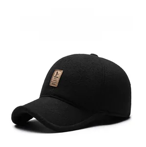 Detailed macro view of black winter baseball cap featuring warm wool texture and leather logo