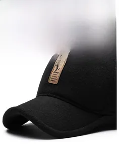 Close-up of the black winter baseball cap with a vintage leather logo and thick wool texture
