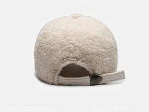 Back view of cream teddy fleece baseball cap with adjustable strap and metal buckle detail