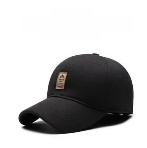 Close-up of thick woven fabric and leather sport patch on a black winter baseball cap