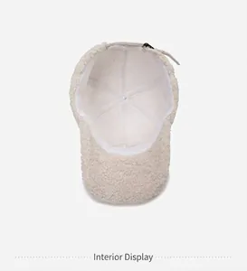 Detailed interior view of beige sherpa baseball cap with smooth stitching and metal buckle