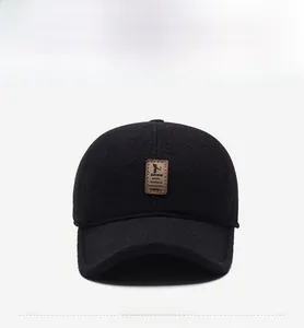 Front view of black winter baseball cap featuring textured wool fabric and a brown leather patch